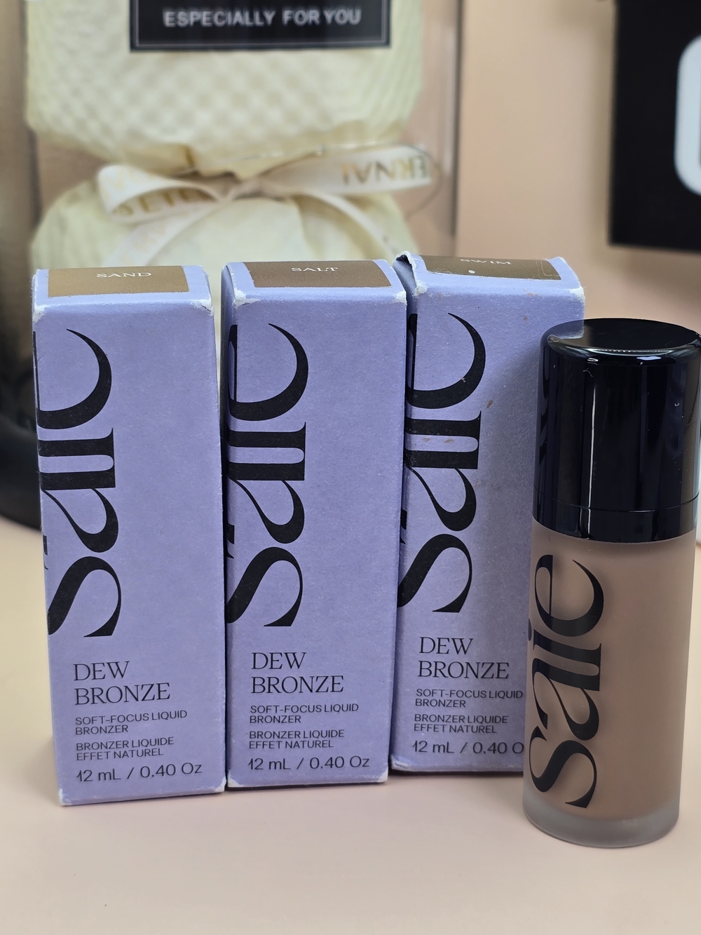 Saie Dew Bronze Liquid Bronzer in Tan with Lavender Packaging